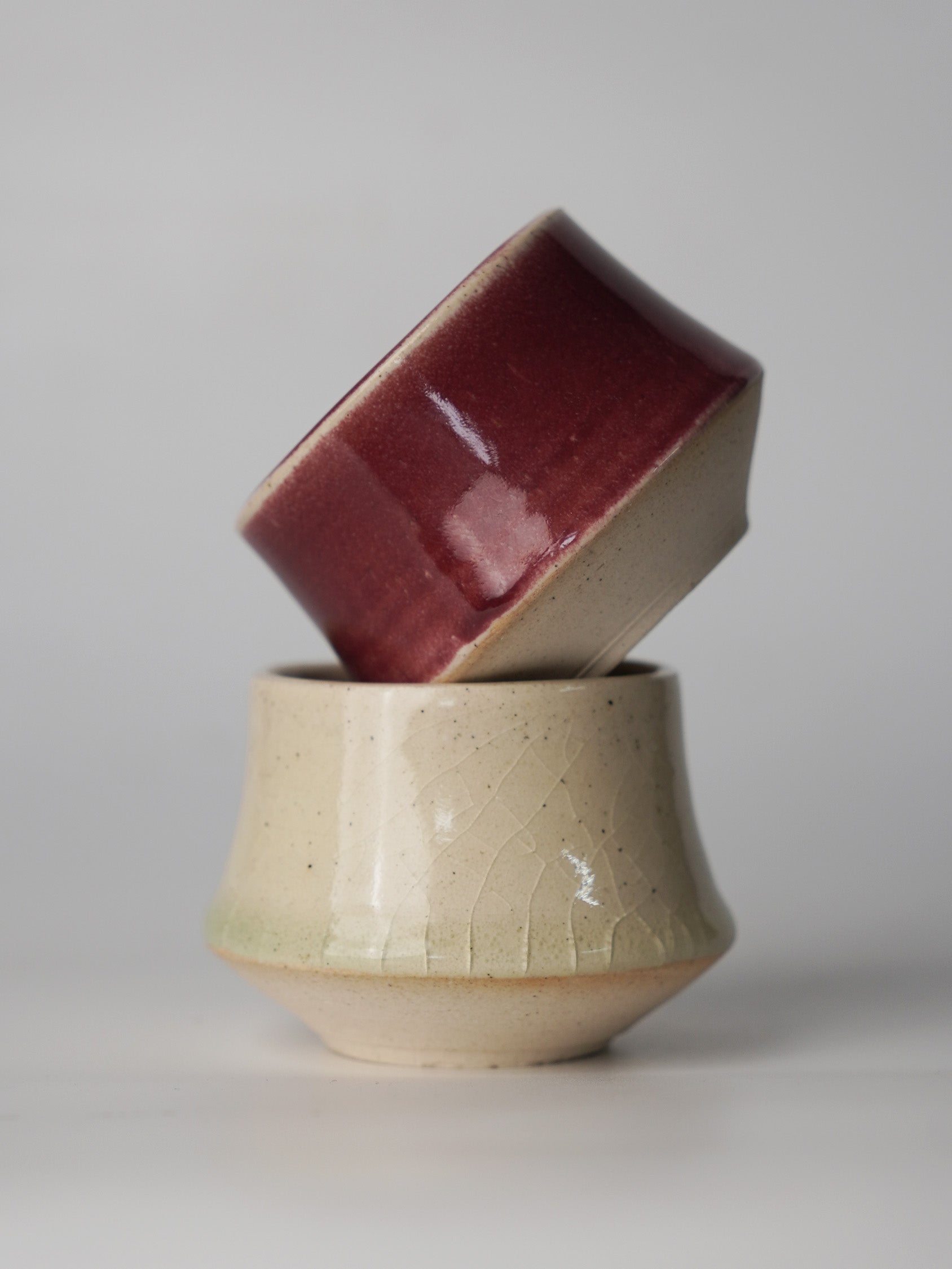 Top view of ceramic espresso cups showing the contrast between high-gloss cherry and matte satin interiors