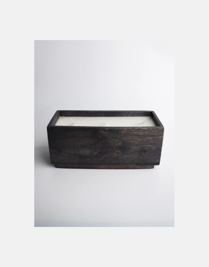Handcrafted Lumen wax candle in a dark-stained mango wood block with multiple wicks