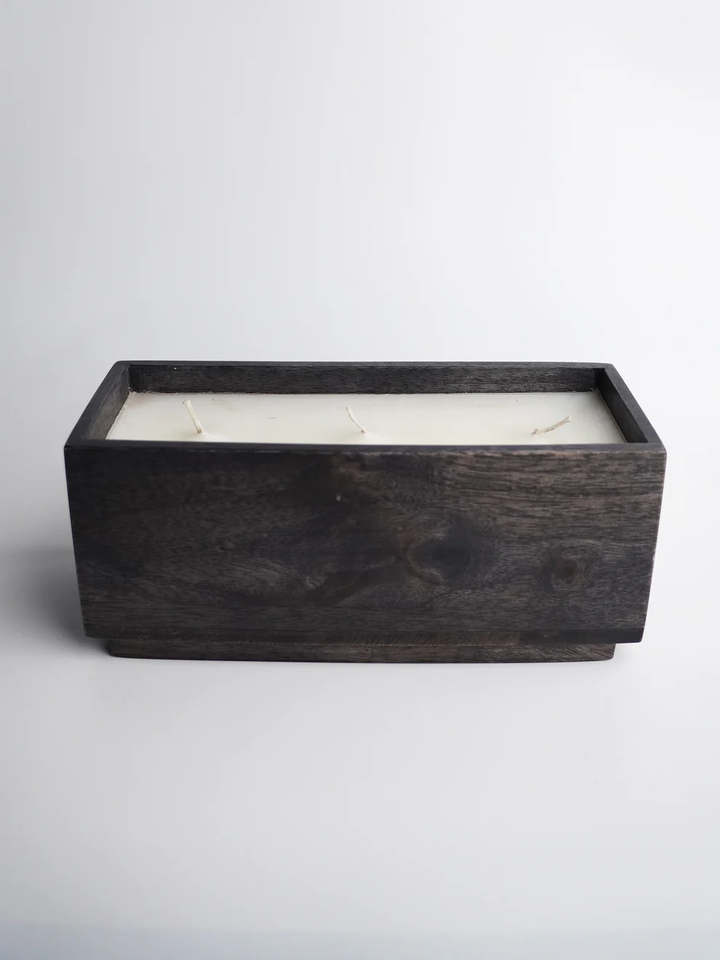 Minimalist dark mango wood candle holder with multiple wicks for modern home ambiance